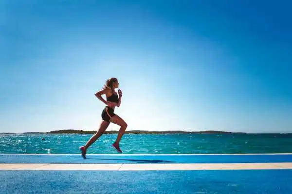 Woman running showing strong leg muscle Gloucestershire